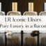 Φωτογραφία των Iconic Elixirs της LR: πολυτελή unisex αρώματα σε γυάλινα μπουκάλια με χρυσό και ασημί καπάκι, τοποθετημένα σε σκοτεινό φόντο με φυσικά αρωματικά στοιχεία